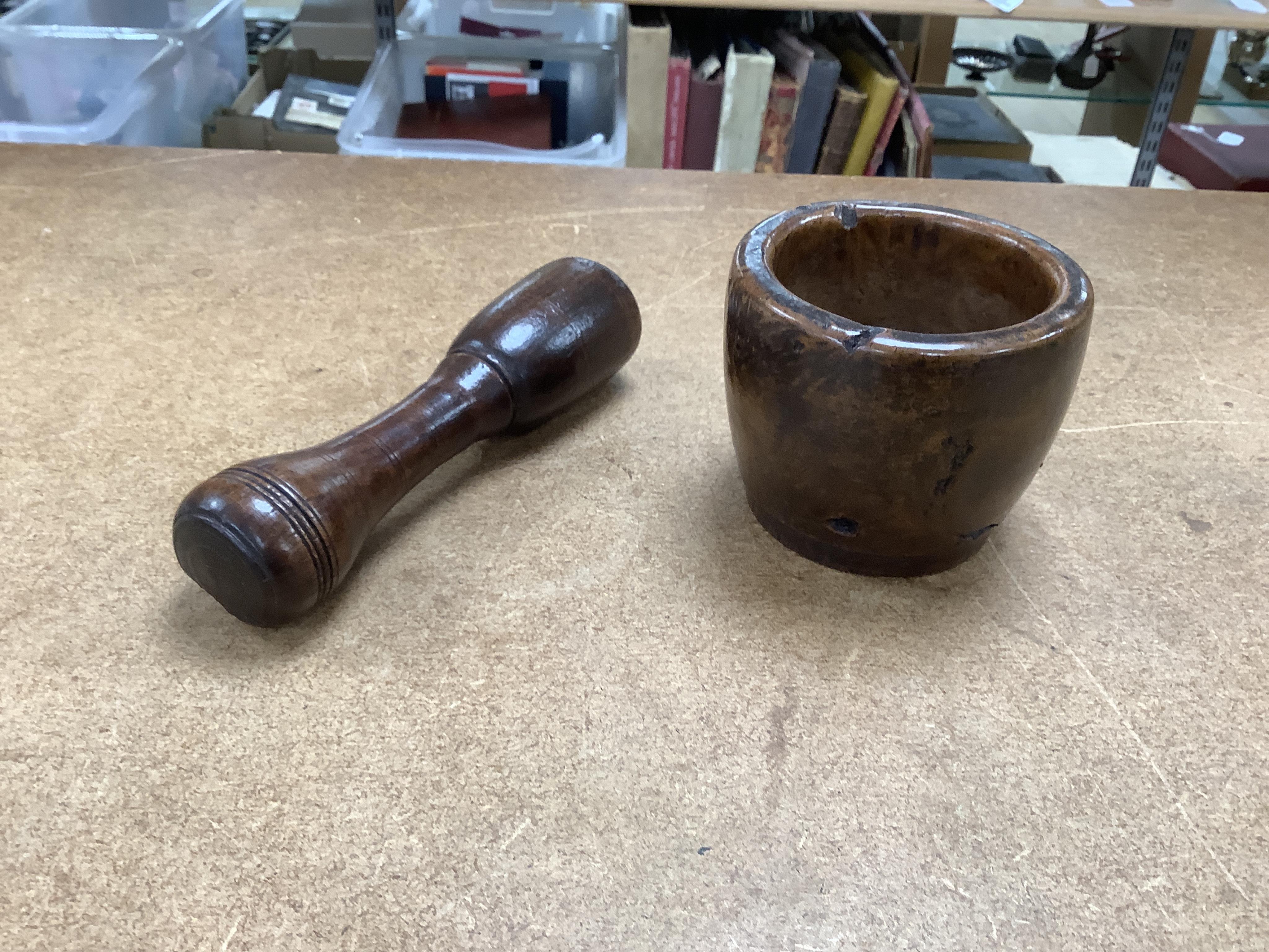 Sundry items to include a large pestle, spice grinder, flat iron on stand, bronze mortar and three other items, largest 42cm in length